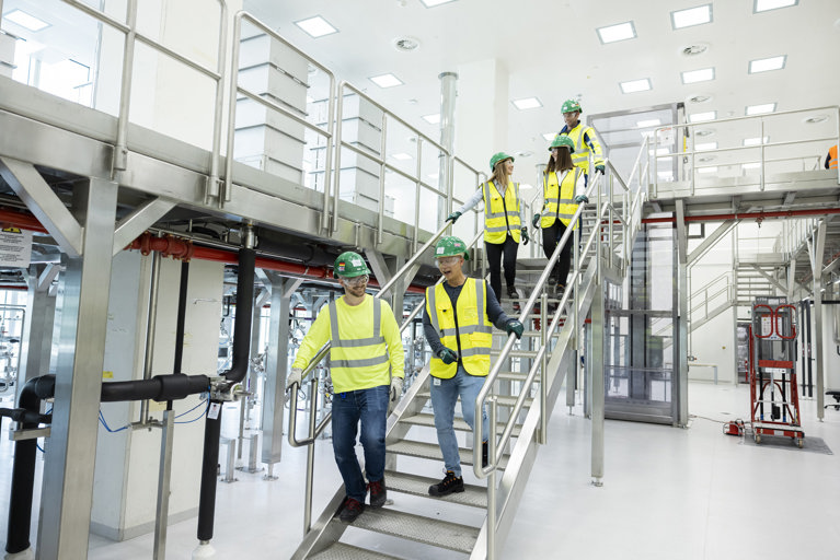 Teva manufacturing employees on the stairs