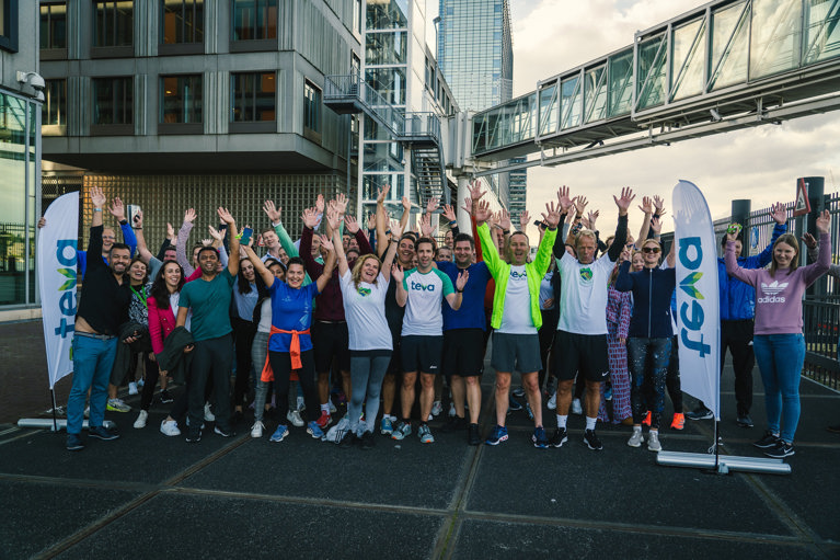 Teva employees waving hands outside in Amsterdam